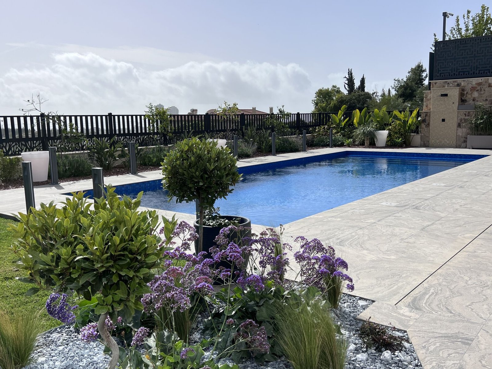 Pool and garden — daytime view with purple flowers