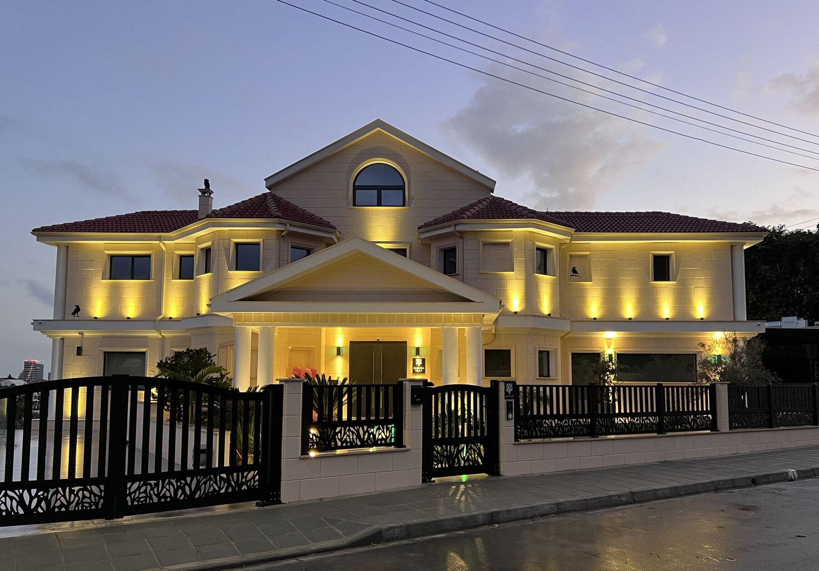 Front façade illuminated at dusk with warm lighting