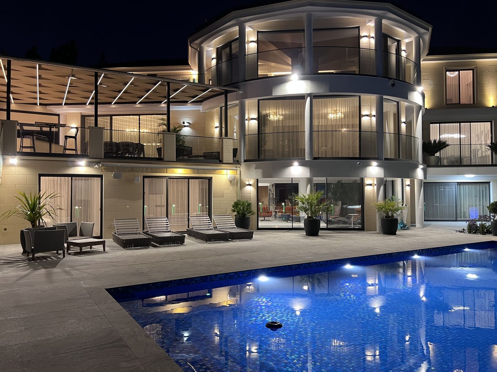 Curved façade with pool at night