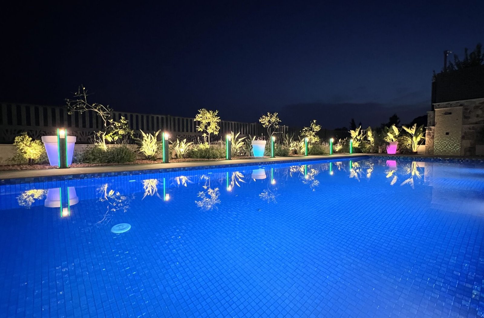 Pool at night with garden lighting