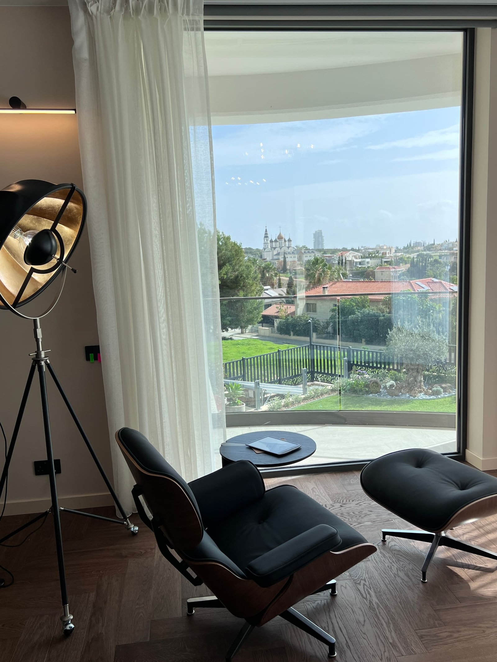 Leather lounger by open glass doors looking onto the pool