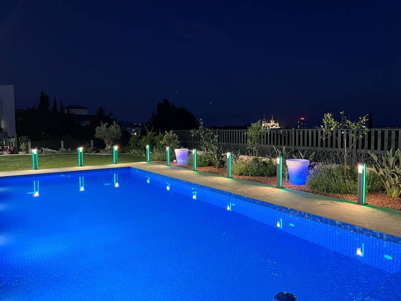 Pool at night with warm garden lighting