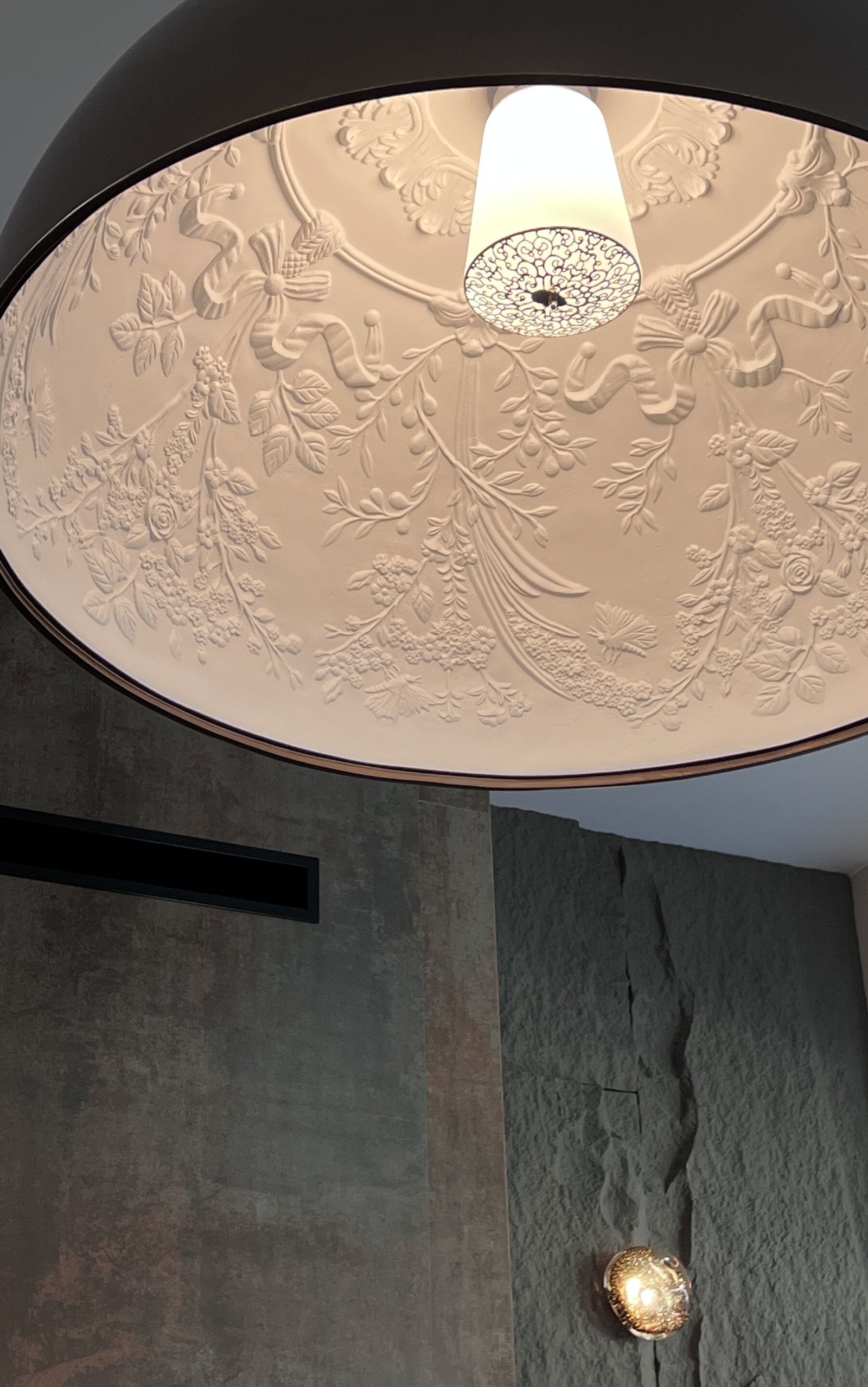 Ornate plaster ceiling rosette with hanging lamp