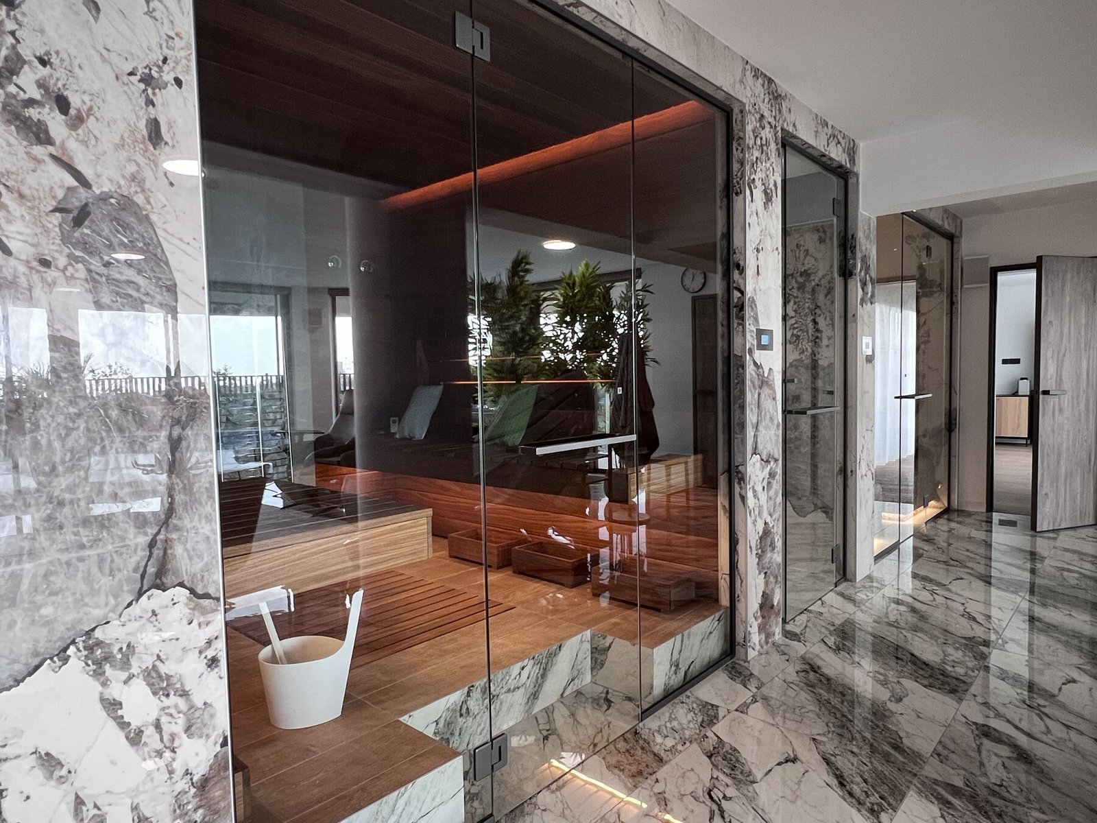 Private sauna in walnut wood and marble