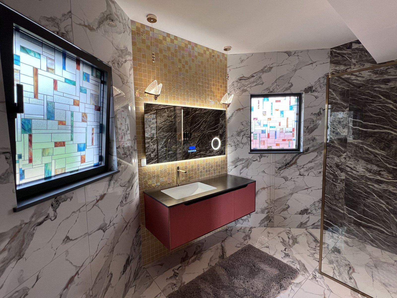 Marble bathroom with TV and walnut detail