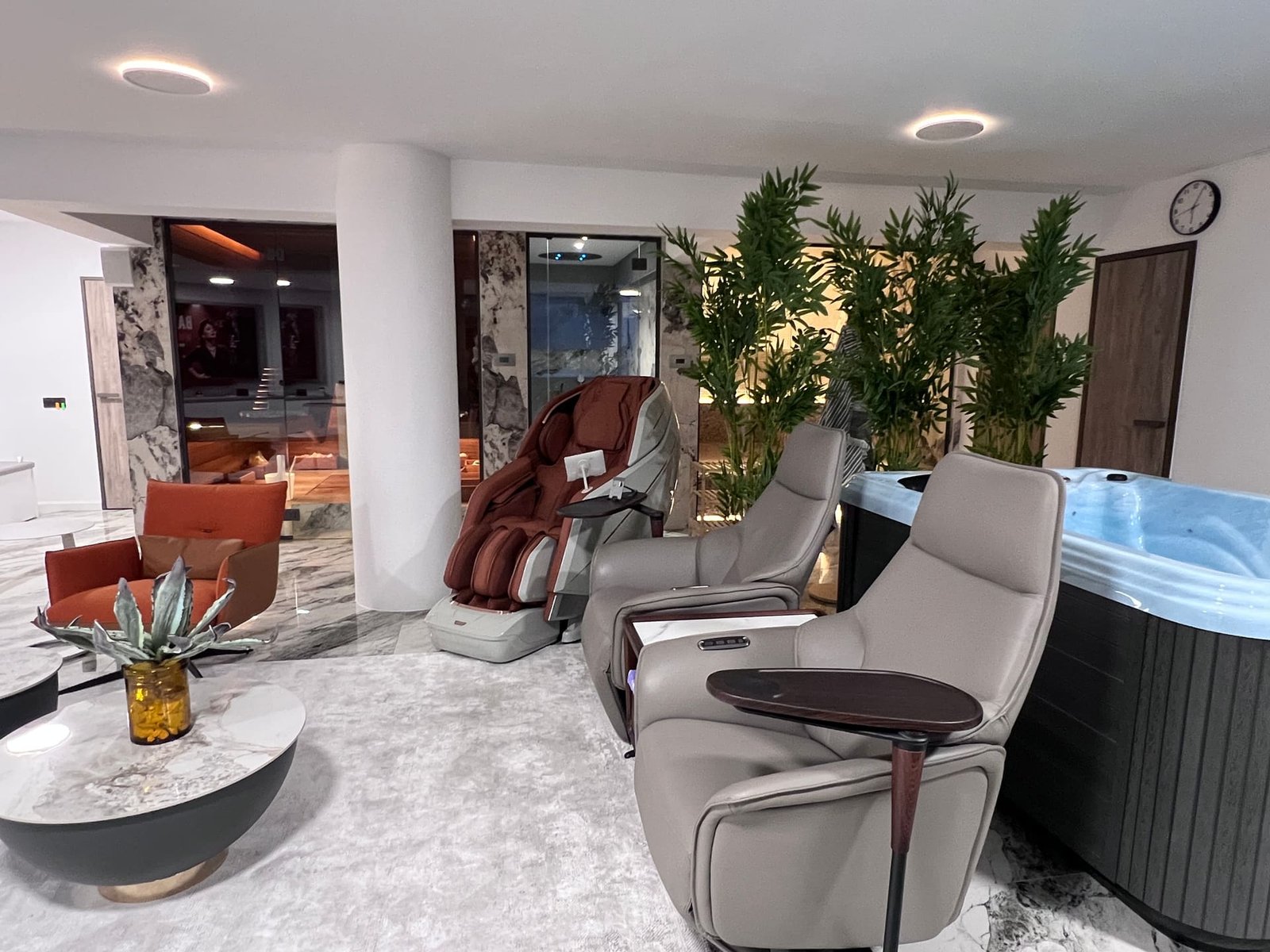 Private wellness lounge with marble and soft terracotta chairs